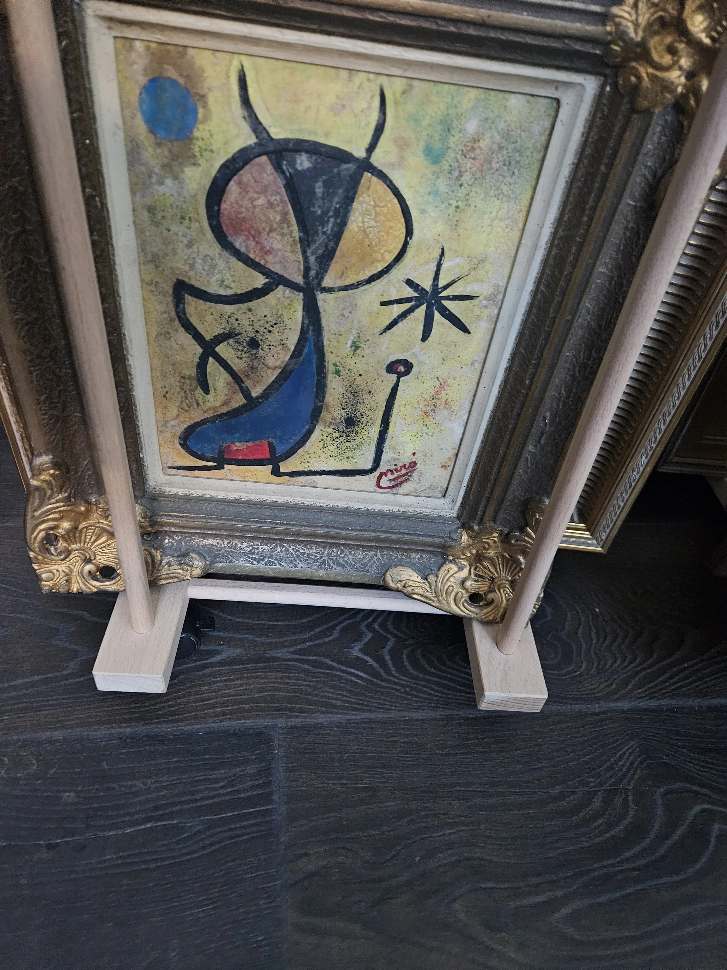 A Pencil drawing of various abstract lines and shaoes placed inside a gold frame.