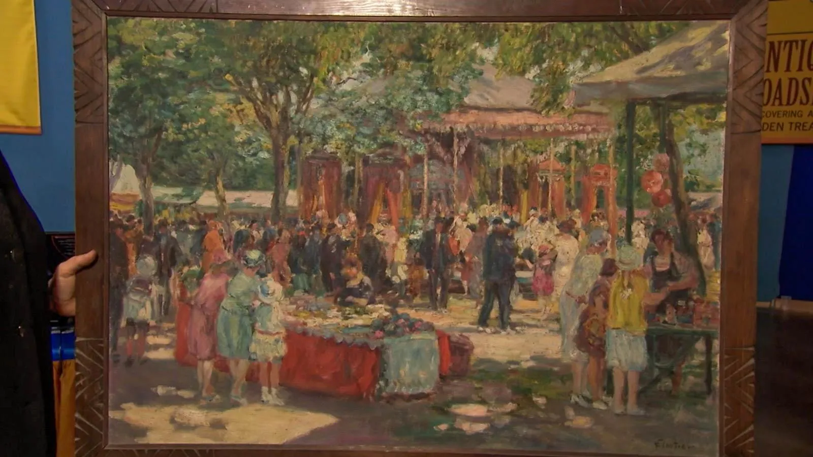 Oil painting displayed in wooden frame. Depicts a large outdoor social gathering that has people surrounding a canopy tent and tables with food.