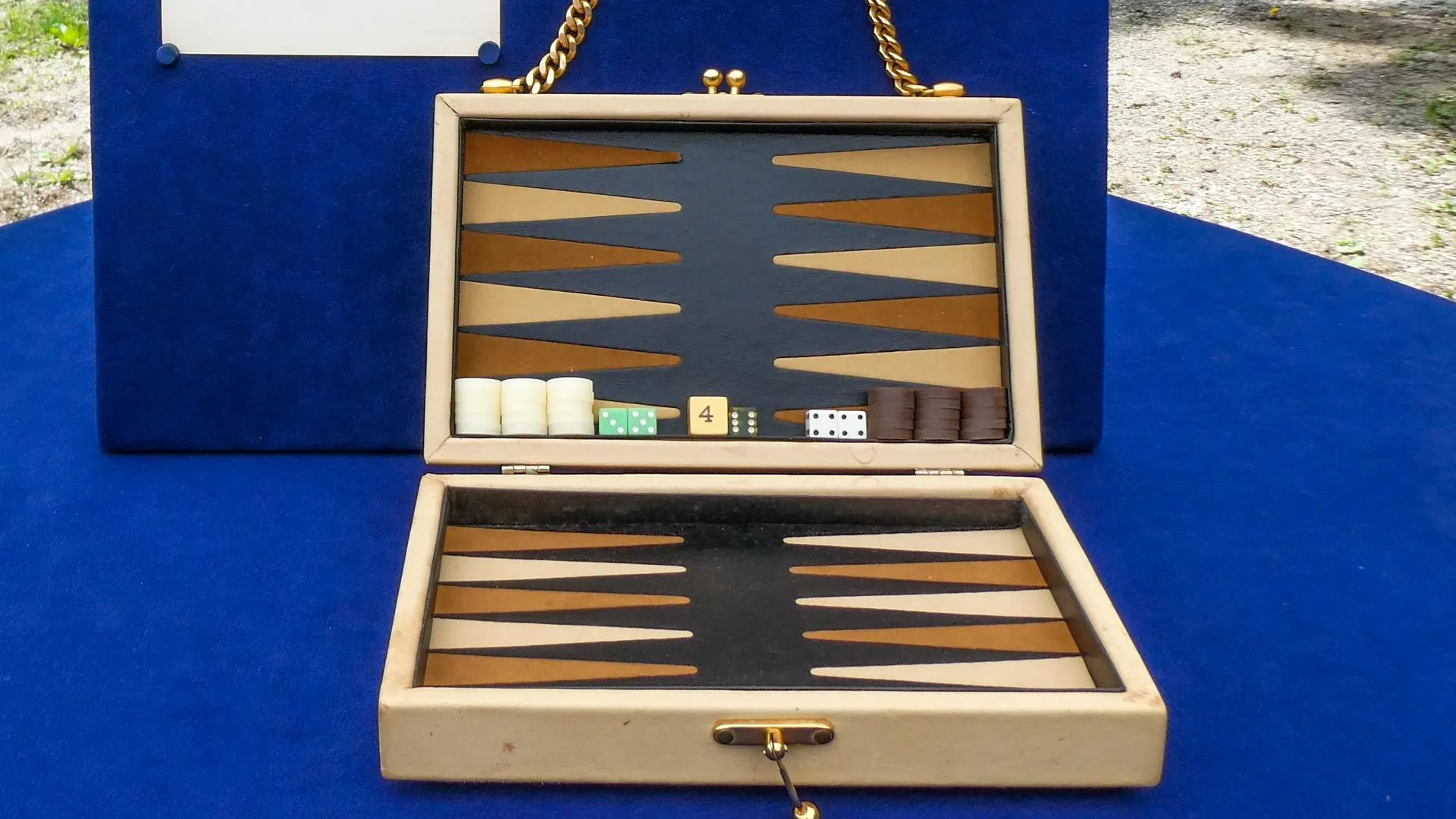 Close up on a small bacgammon board with various dice and poker chips.