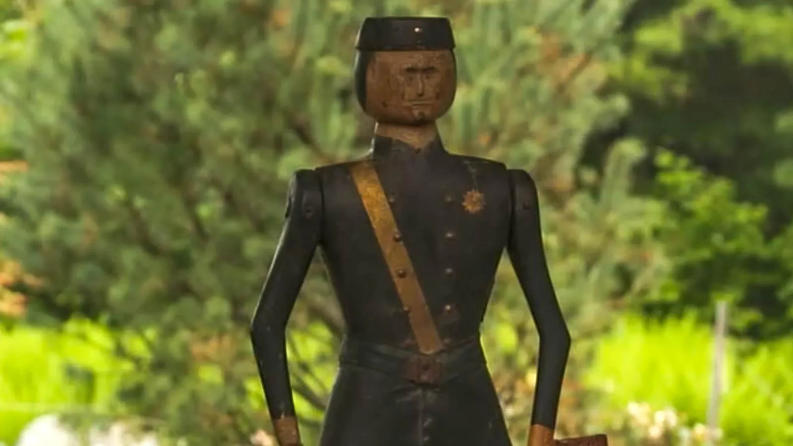 Close up of wooden solier with brass accents dressed in a navy colored uniform.