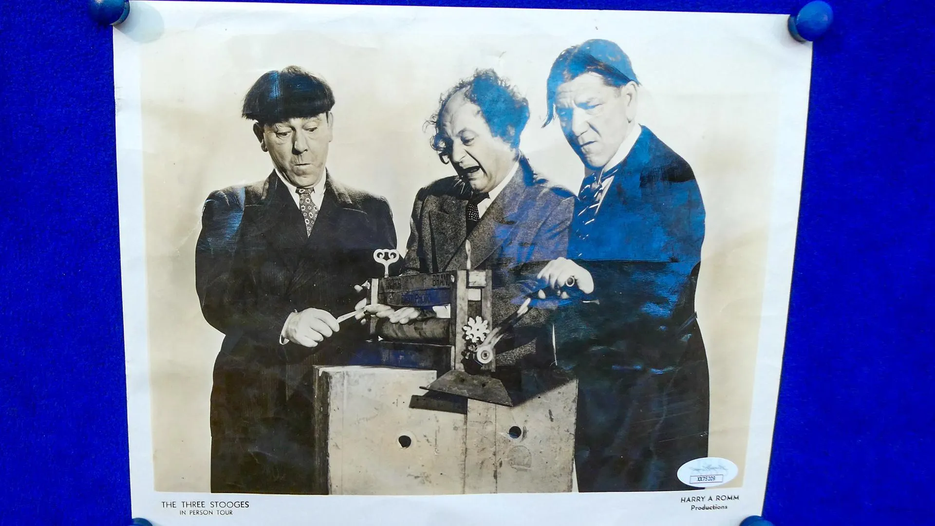 Photo of the three stooges mounted on a blue display board