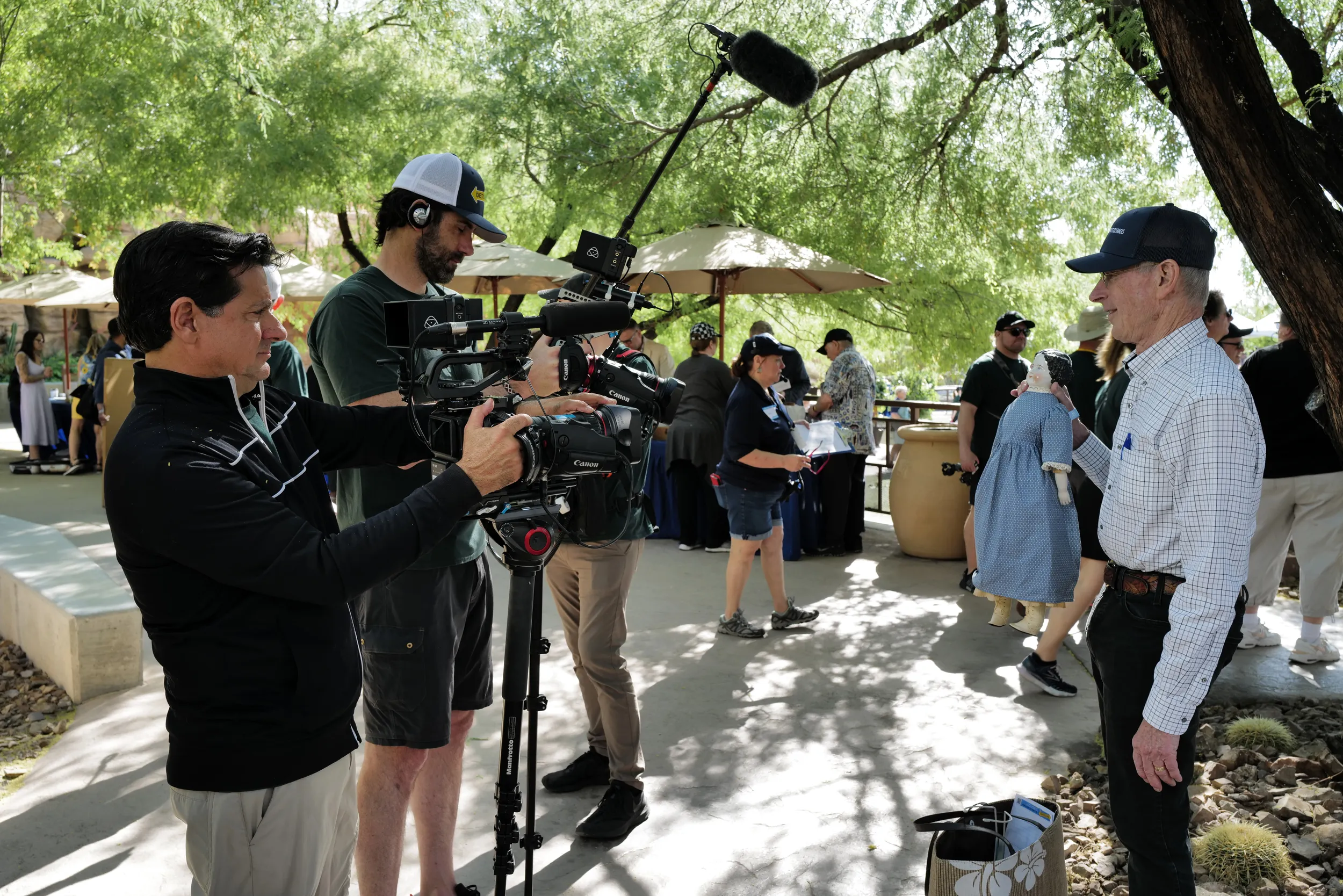 ROADSHOW's snapshot crew films a guest speaking about a doll he brought.