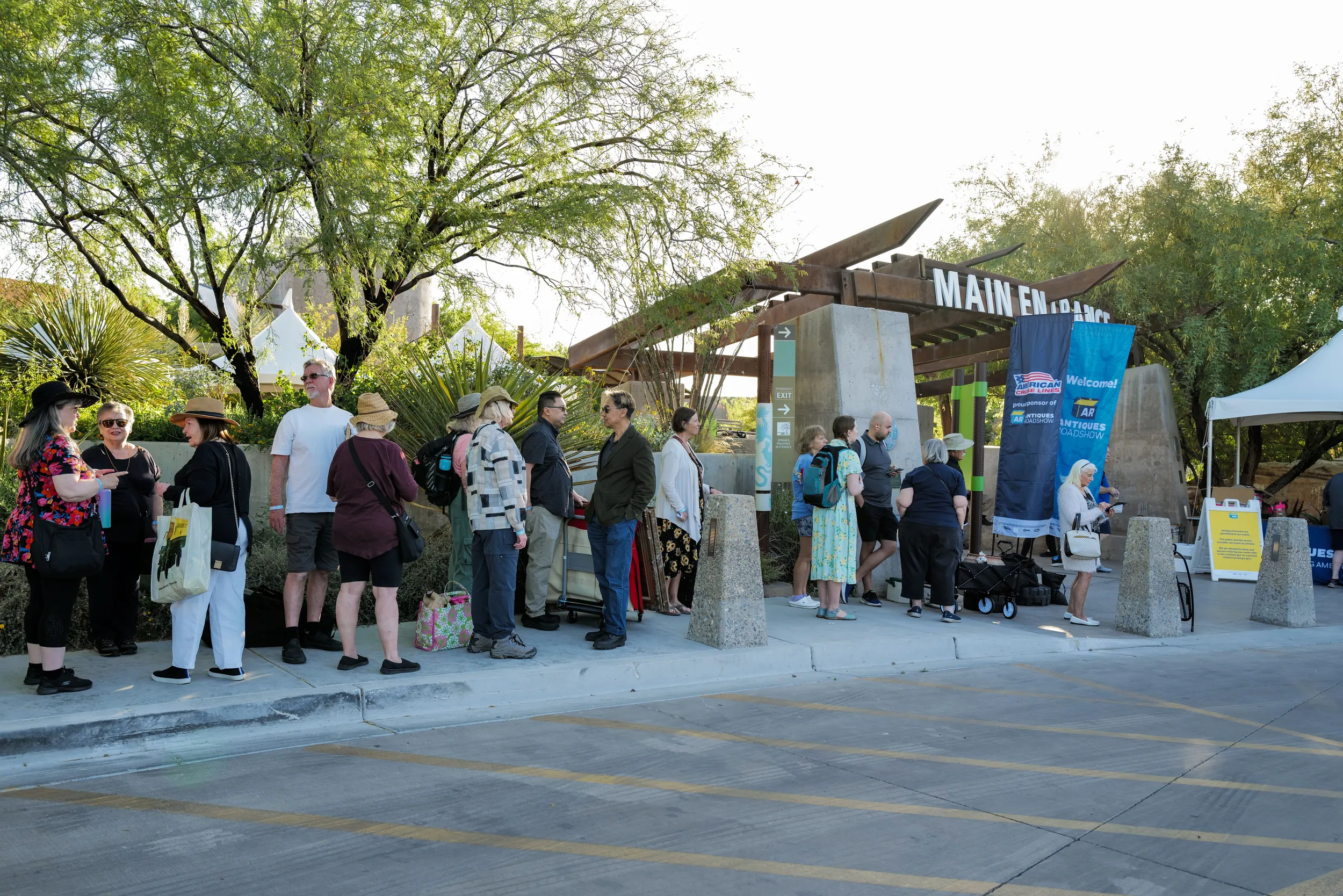 A long crowd gather's outside of the entrance to Springs Preserve in Las Vegas.