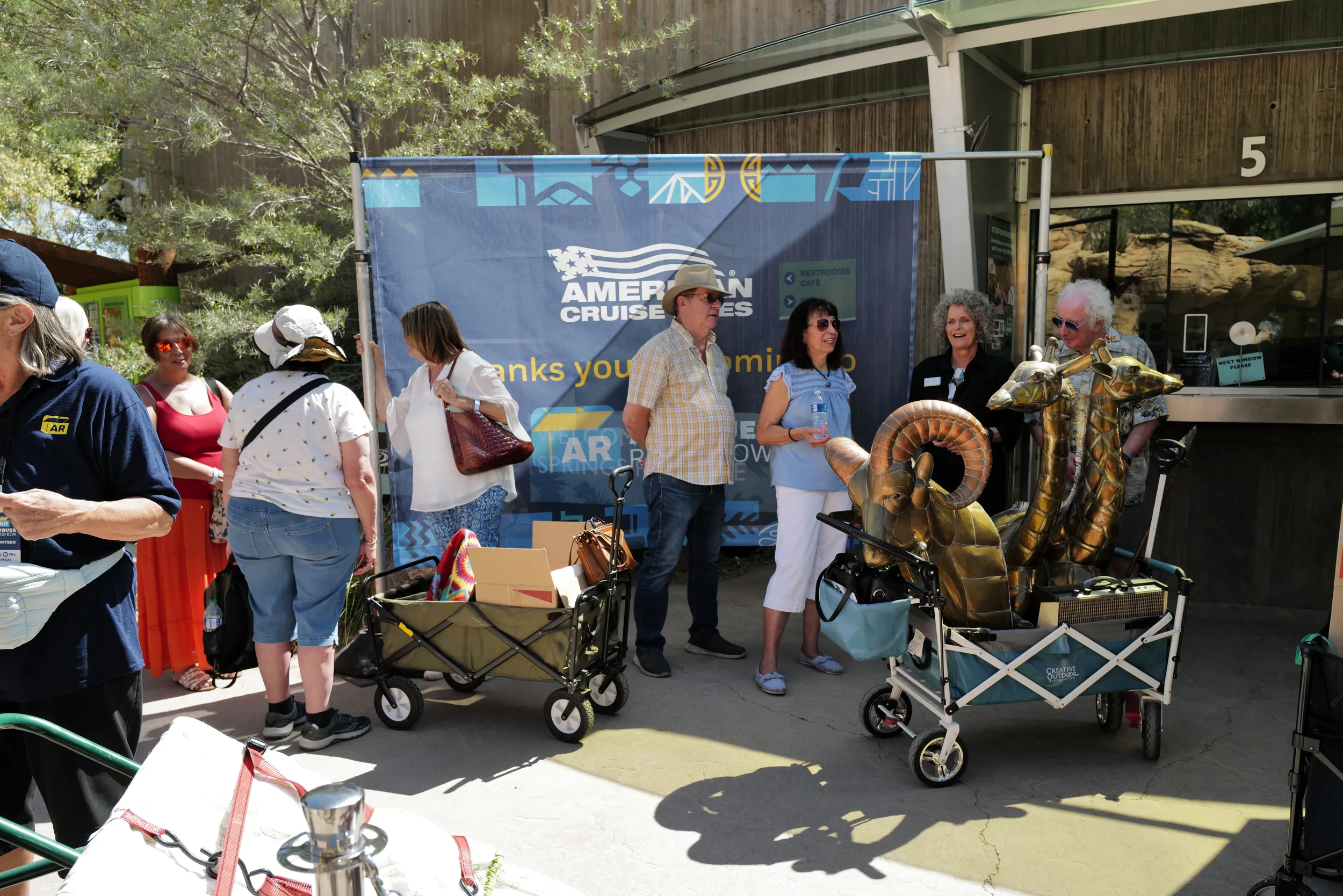 A crowd lines up outside waiting for their items to be appraised.
