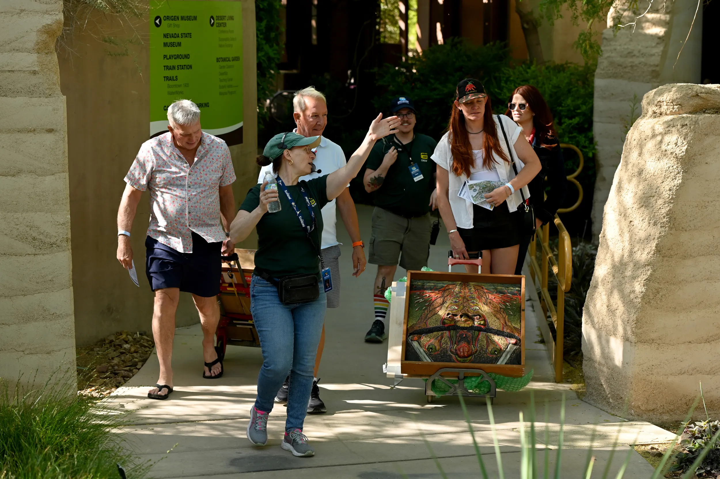 A ROADSHOW crew member leads a group of guests through a shady path in Springs Preserve.