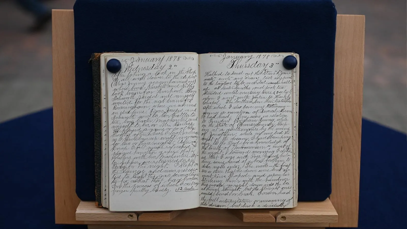 A journal is open, with the title, Tuesday, January 1878. The pages are written in long loose cursive.