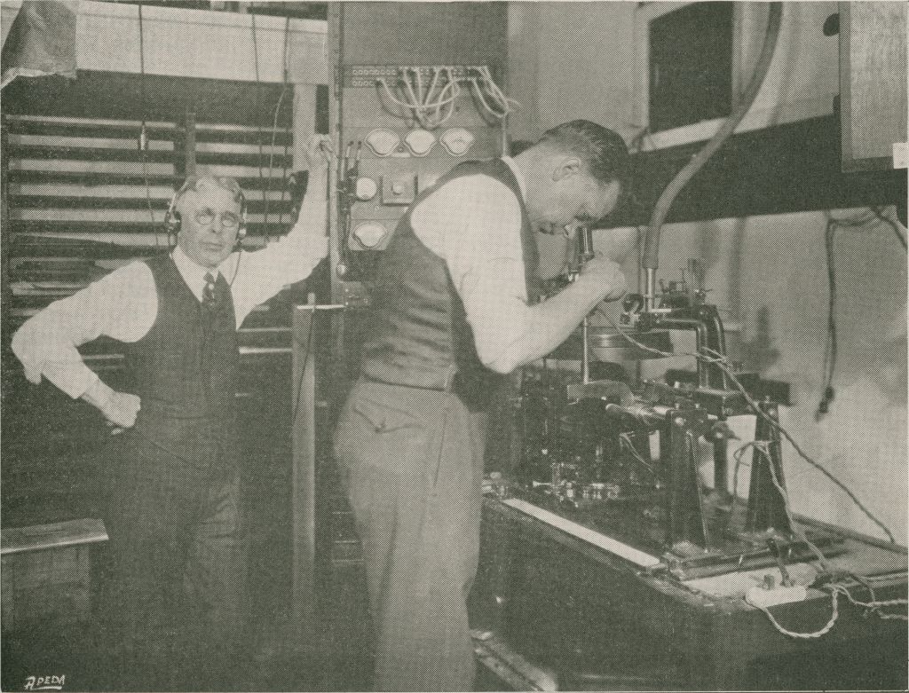 Okeh Engineers Charles L. Hibbard and Peter P. Decker with Western Electric Amplifier and Cutting Lathe Appearing in “American Epic: The Big Bang.” Credit: Maida Vale Music