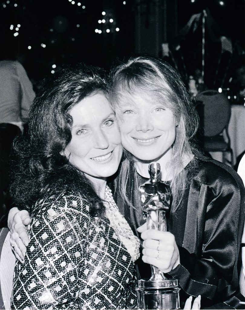 Loretta Lynn & Sissy Spacek who is holding the Oscar she won playing Loretta Lynn.