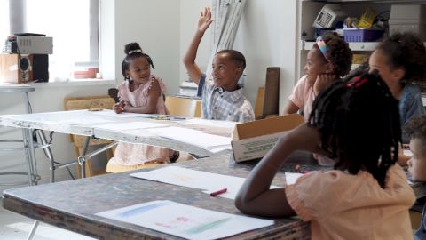 Black children sitting at desks in a classroom