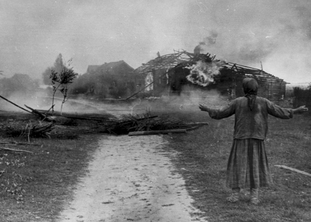 Russian peasant watches building burn.