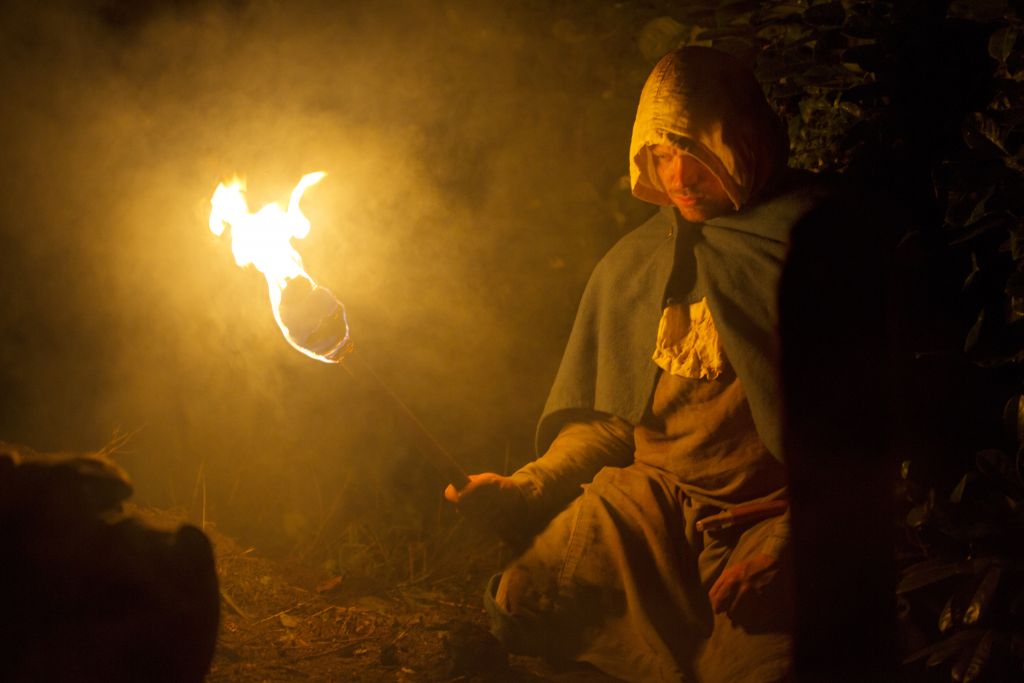 Dramatic re-enactment, Saxon/early medieval man at a grave side preparing to carry out an anti-vampire ritual.