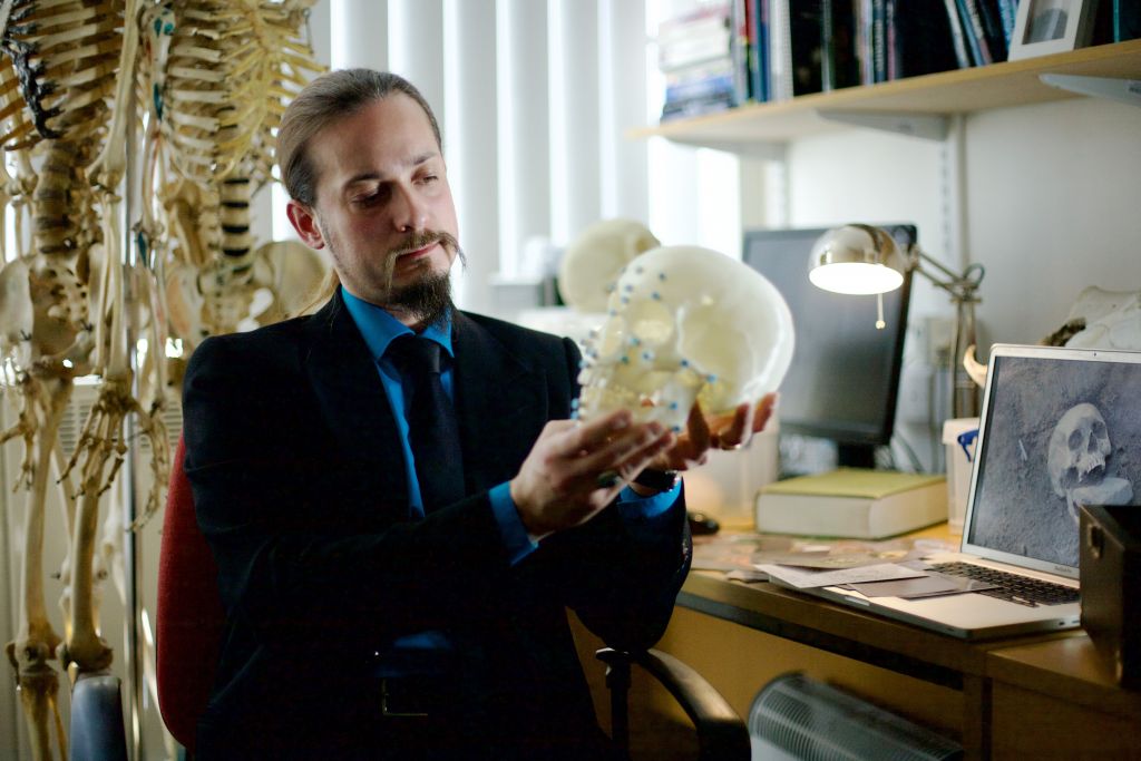 Professor Matteo Borrini, with the reconstructed skull of the "vampire" from the Venice plague pit.