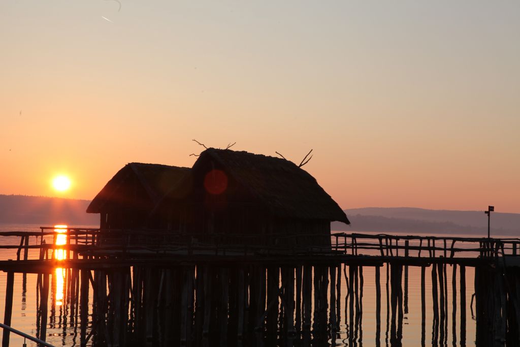 Sunset over stilt houses in lake