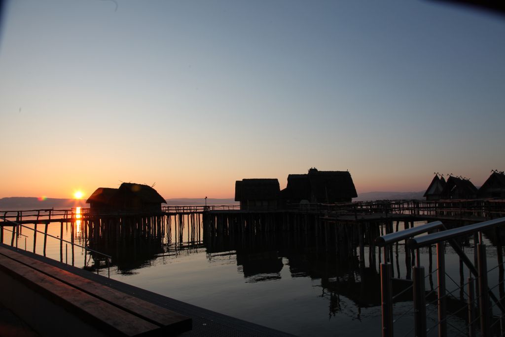 Sunset over stilt houses in lake