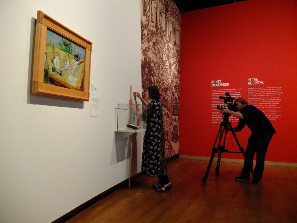 Behind-the-scenes filming of the preparation for the exhibition "On The Verge of Insanity:  Van Gogh & His Illness".  Artwork in foreground is Still Life with a Plate of Onions, 1889, Vincent van Gogh